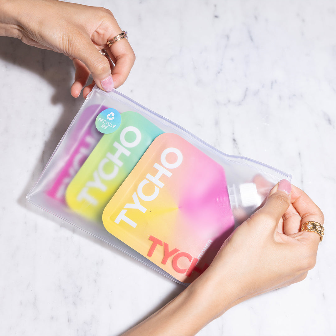 TYCHO's complete travel set, including 30ml pouches of shampoo, conditioner, and body wash, elegantly packaged in a frosted waterproof bag, ideal for those seeking on-the-go luxury.