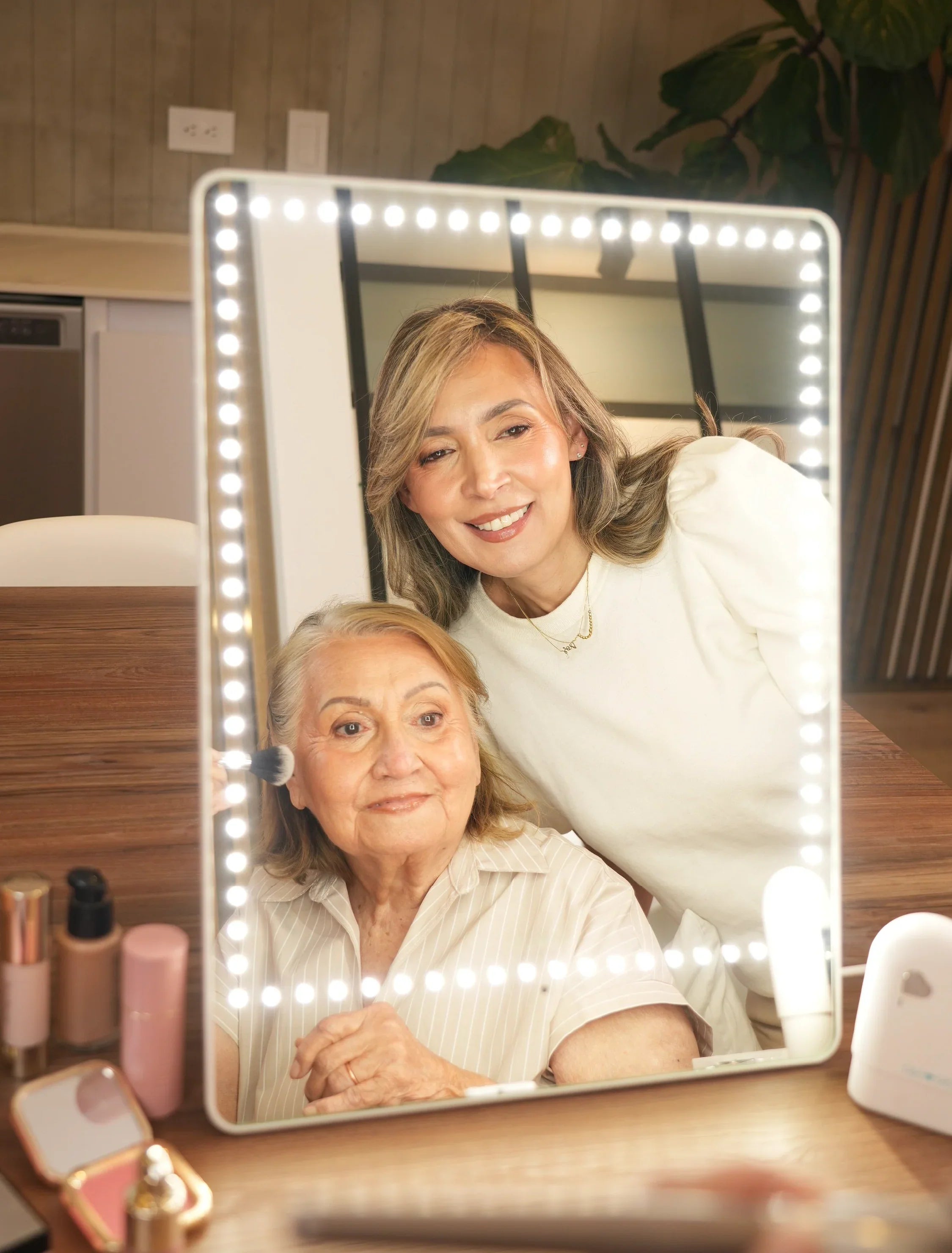 Woman applying makeup with a lighted mirror to counter harsh hotel bathroom lighting