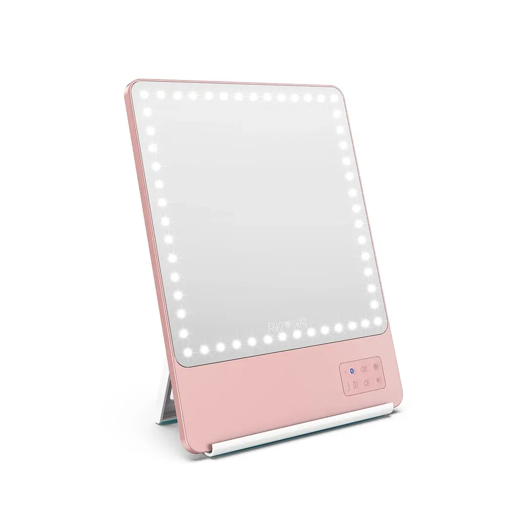 Angled view of the rose gold RIKI SKINNY makeup mirror with stand