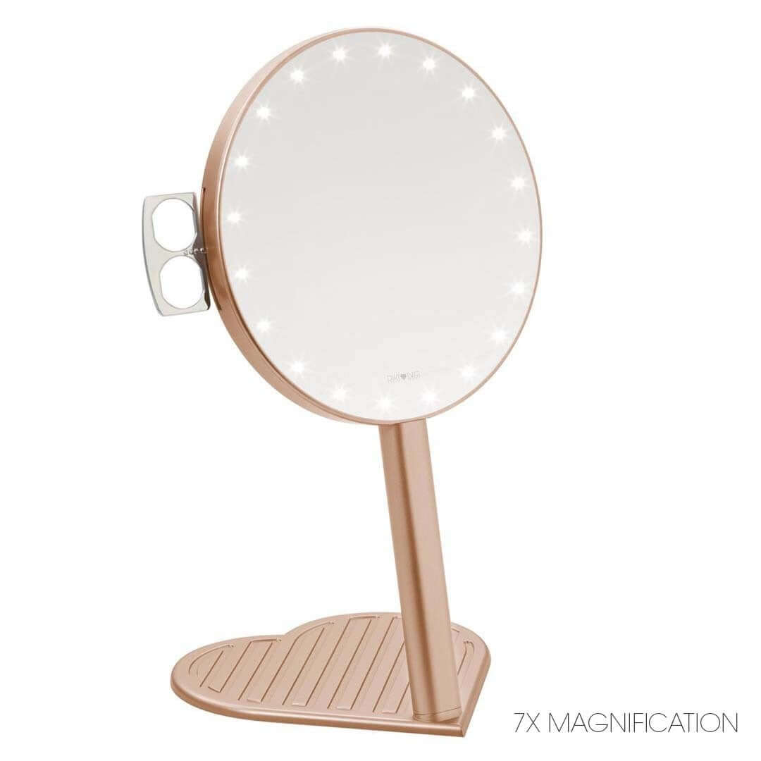 The RIKI GRACEFUL handheld magnifying face mirror in white, featuring 7X magnification, LED lights, and a charming heart-shaped base.