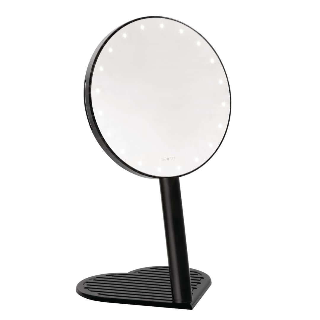 The RIKI GRACEFUL handheld magnifying face mirror in black kit, featuring 7X magnification, LED lights, and a charming heart-shaped base.