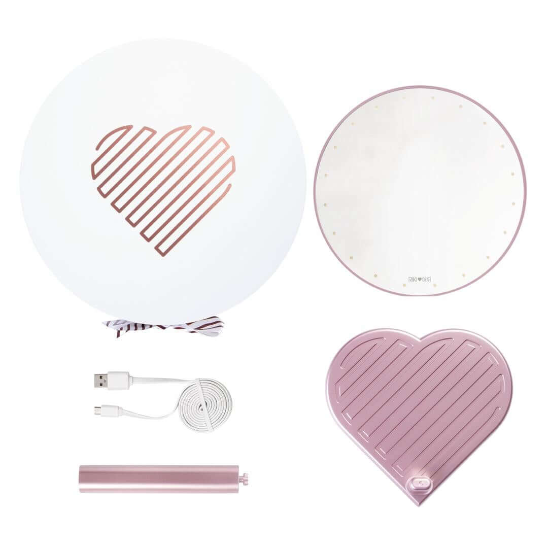 The RIKI GRACEFUL handheld magnifying face mirror in white kit, featuring 7X magnification, LED lights, and a charming heart-shaped base.