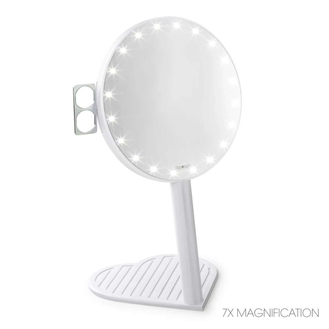 The RIKI GRACEFUL handheld magnifying face mirror in champagne gold, featuring 7X magnification, LED lights, and a charming heart-shaped base.