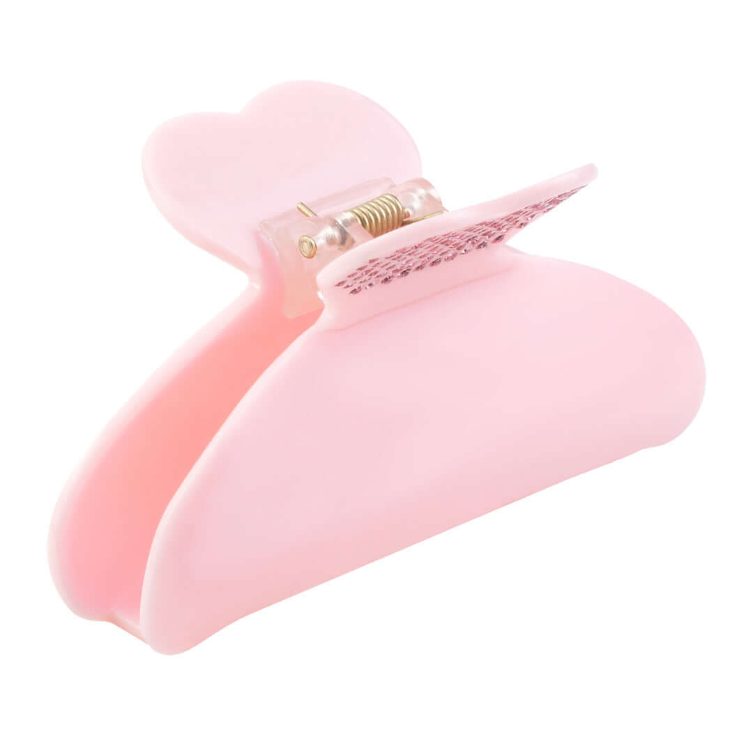 Side view of the pink RIKI Hair Clip, showcasing crystal hearts and an interlocking claw closure.