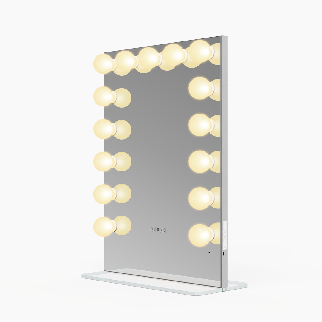Side view of the small Riki Loves Riki Hollywood mirror with warm light.