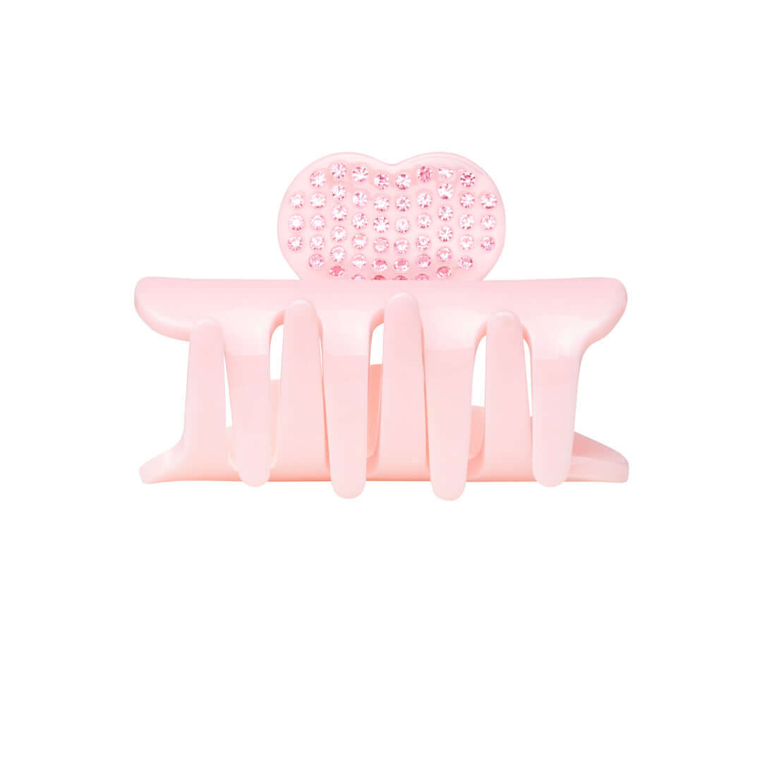 Small pink RIKI Hair Clip adorned with crystal hearts, perfect for a subtle touch of glam.