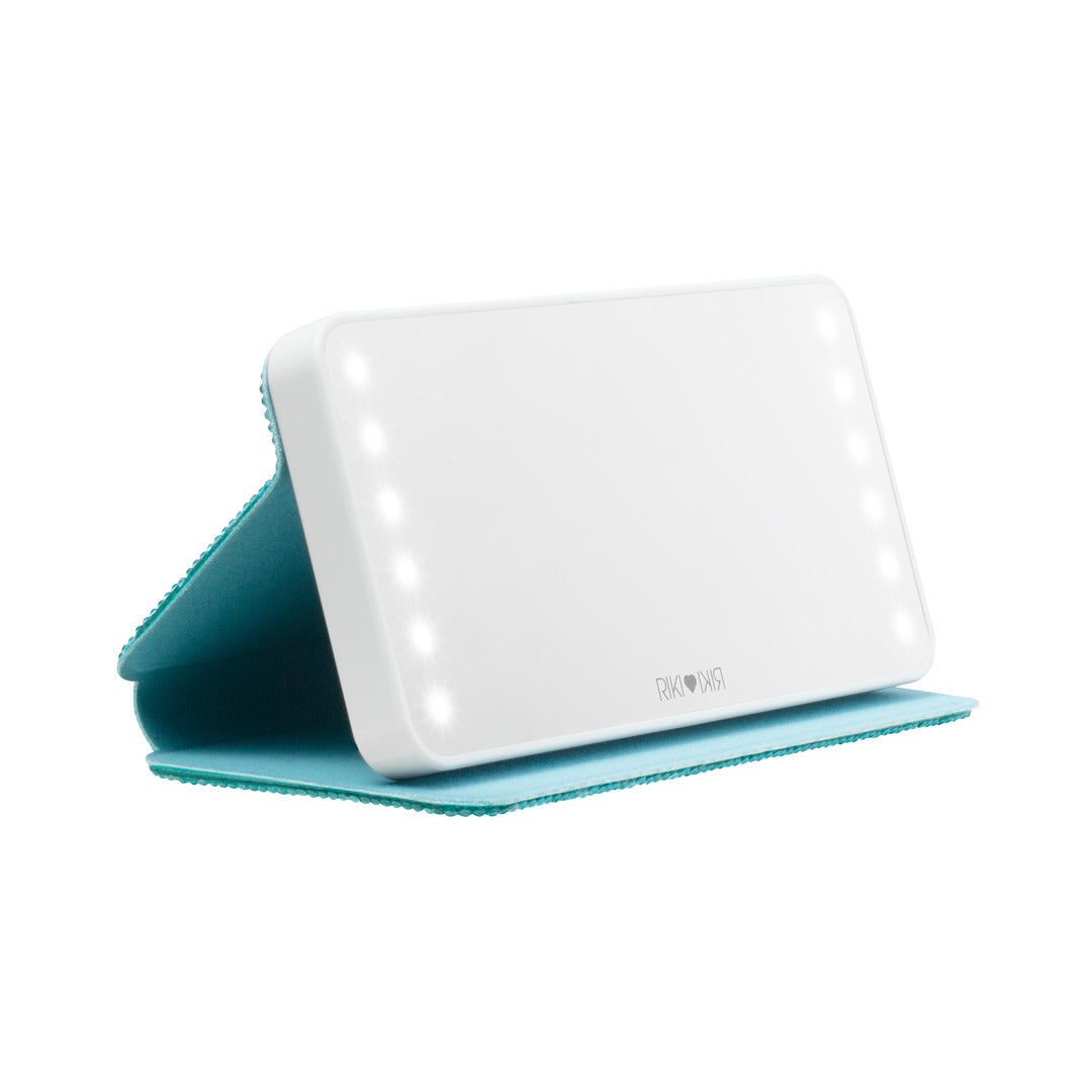 Cover stand for the Sparkle RIKI Powerful LED-lighted mirror and power bank in blue by RIKI LOVES RIKI, designed for easy touch-ups on the go with a portable makeup mirror.