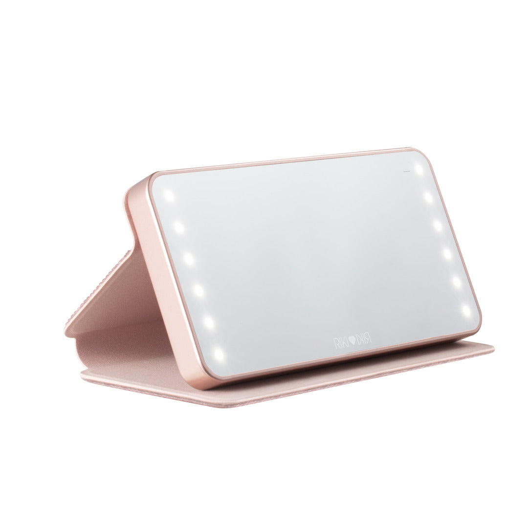 Cover of the rose gold Sparkle RIKI Powerful LED-lighted mirror and power bank by RIKI LOVES RIKI, adding sophistication to your beauty routine.